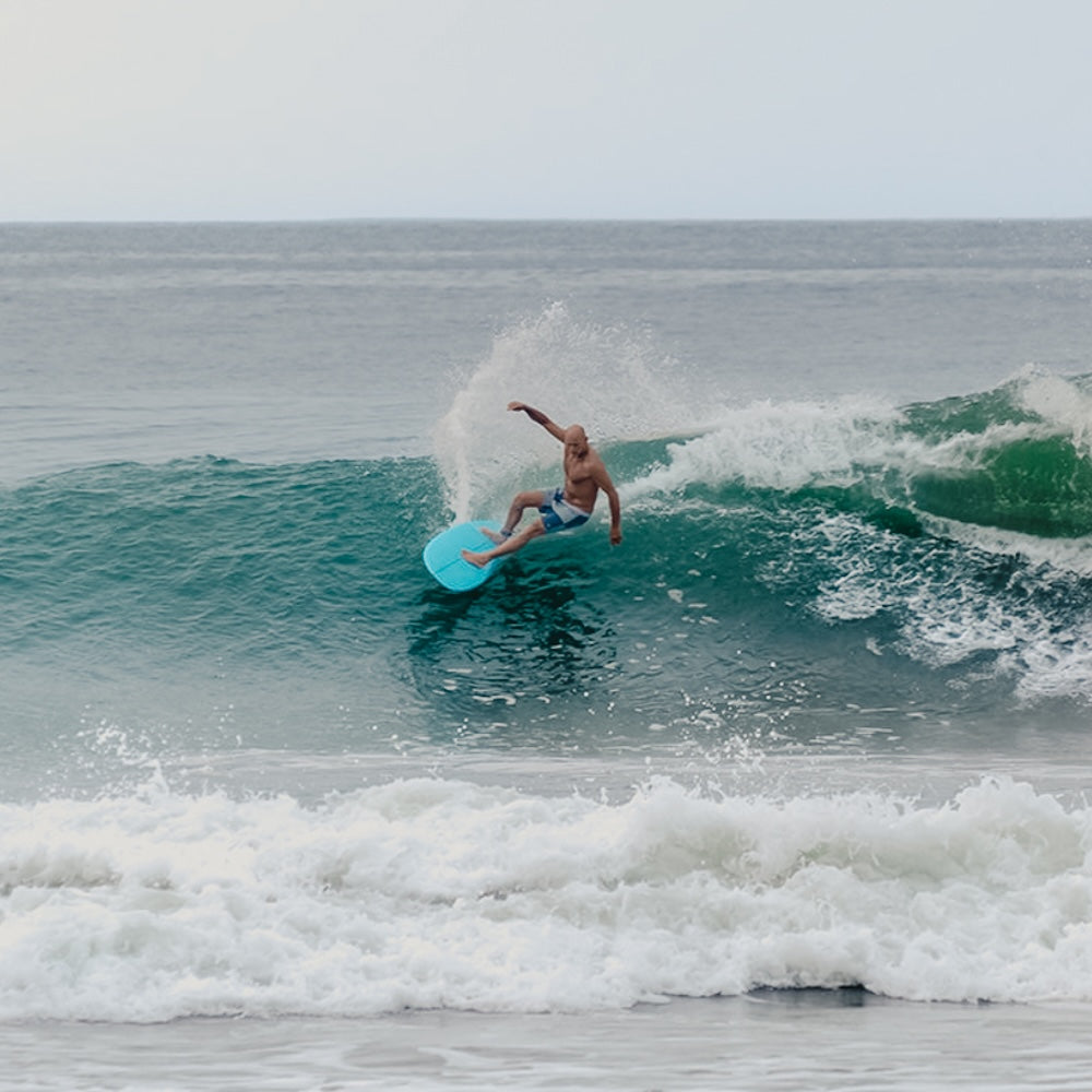 Person surfing on a wave in the ocean