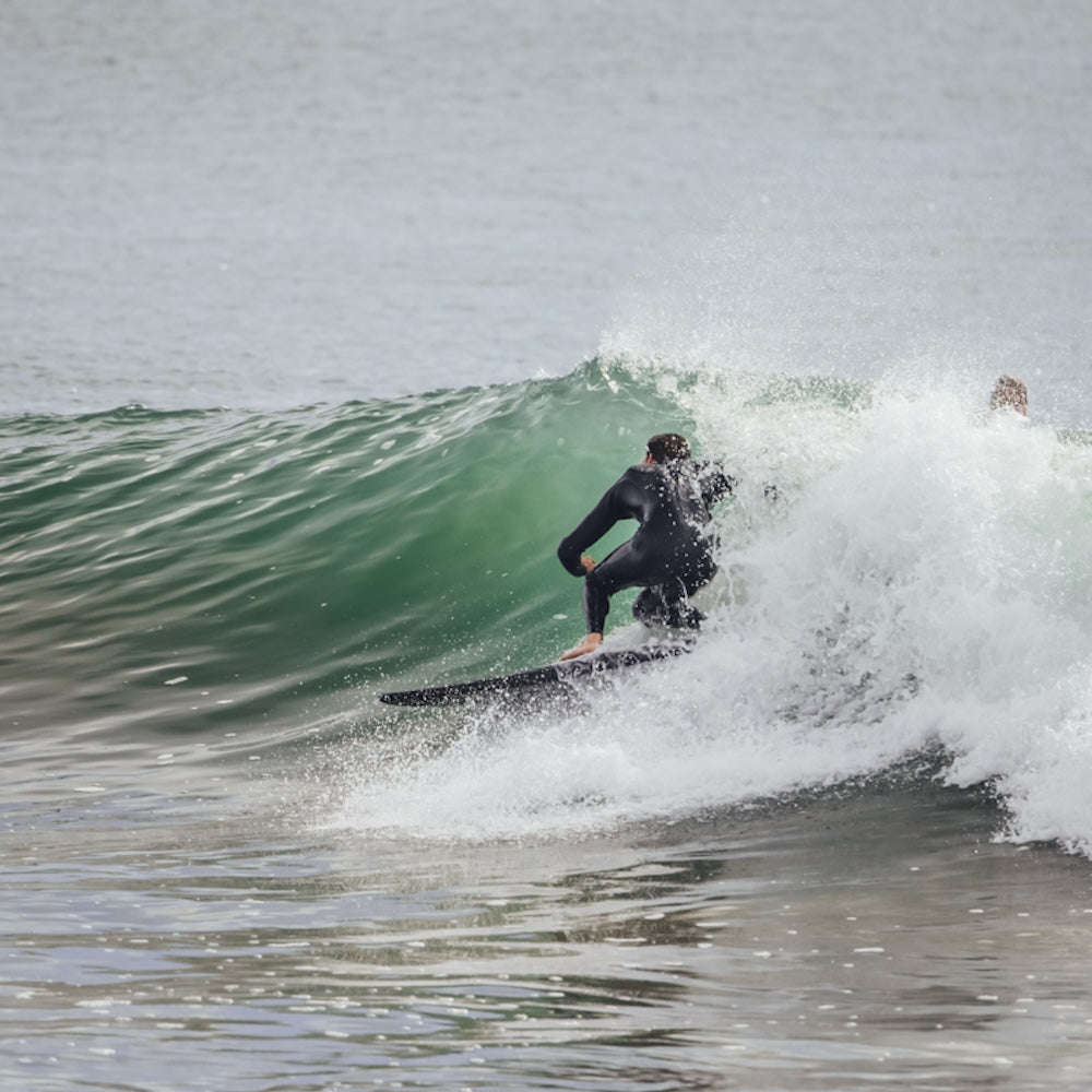 Person surfing on a wave in the ocean