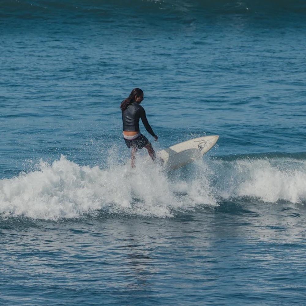 Person surfing on a wave in the ocean