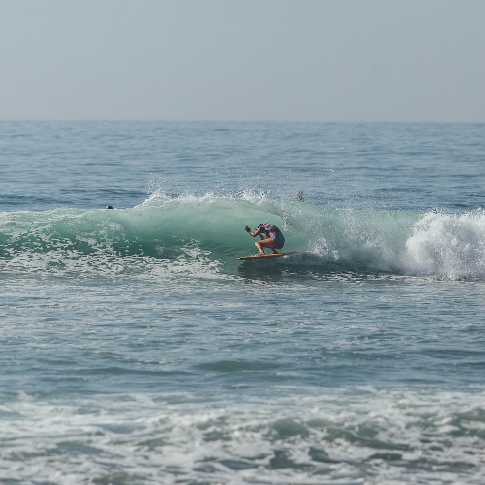 Person surfing on a wave in the ocean