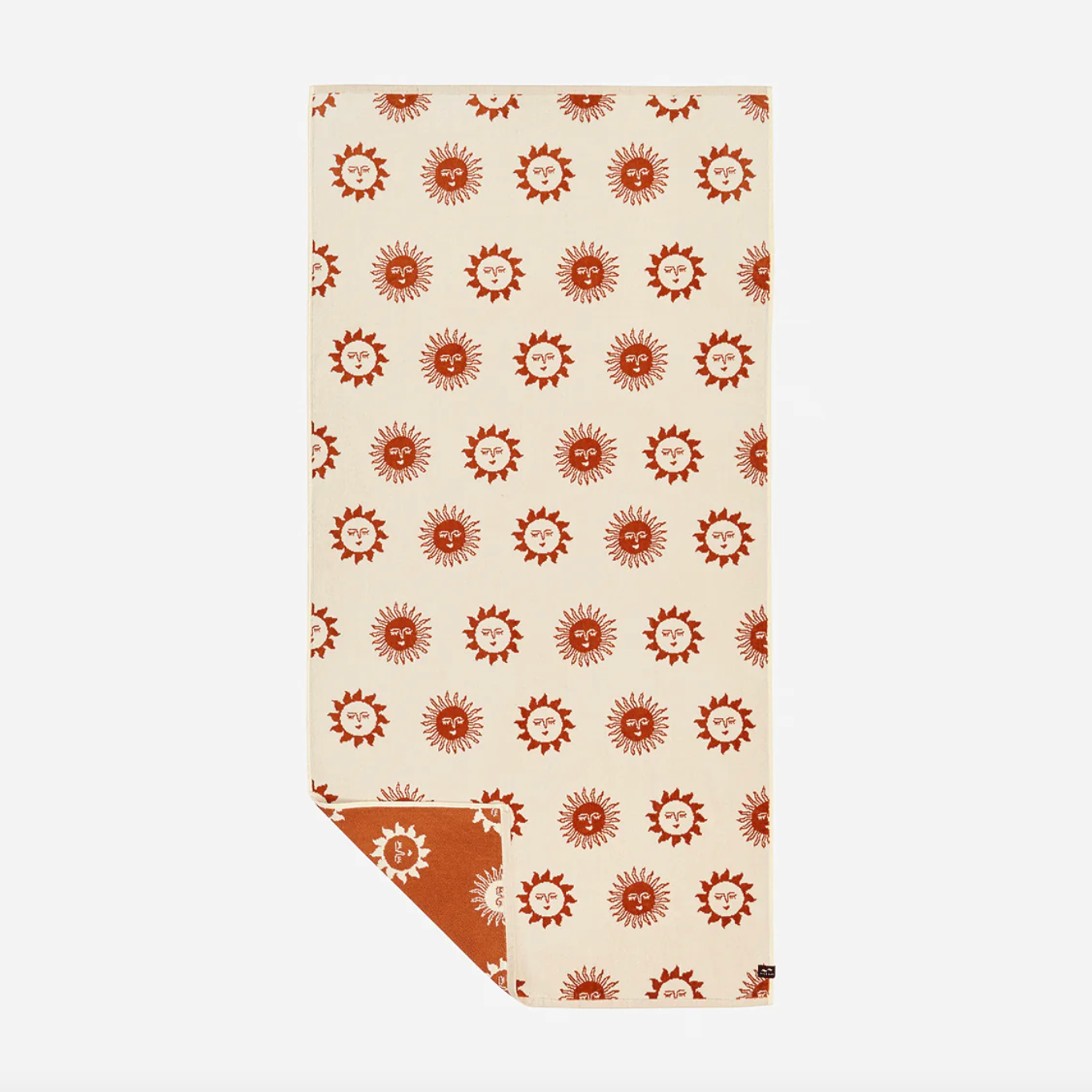 Beige towel with red sun pattern on a white background
