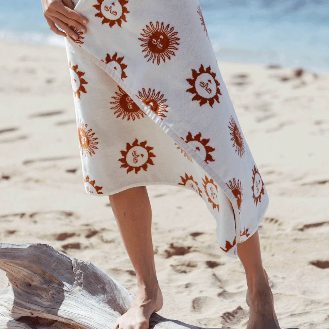 Beige towel with red sun pattern on a white background