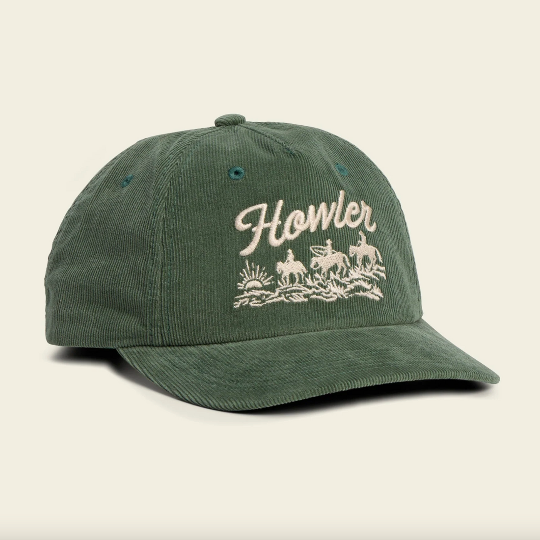 Green cap with 'Howler' logo on a beige background