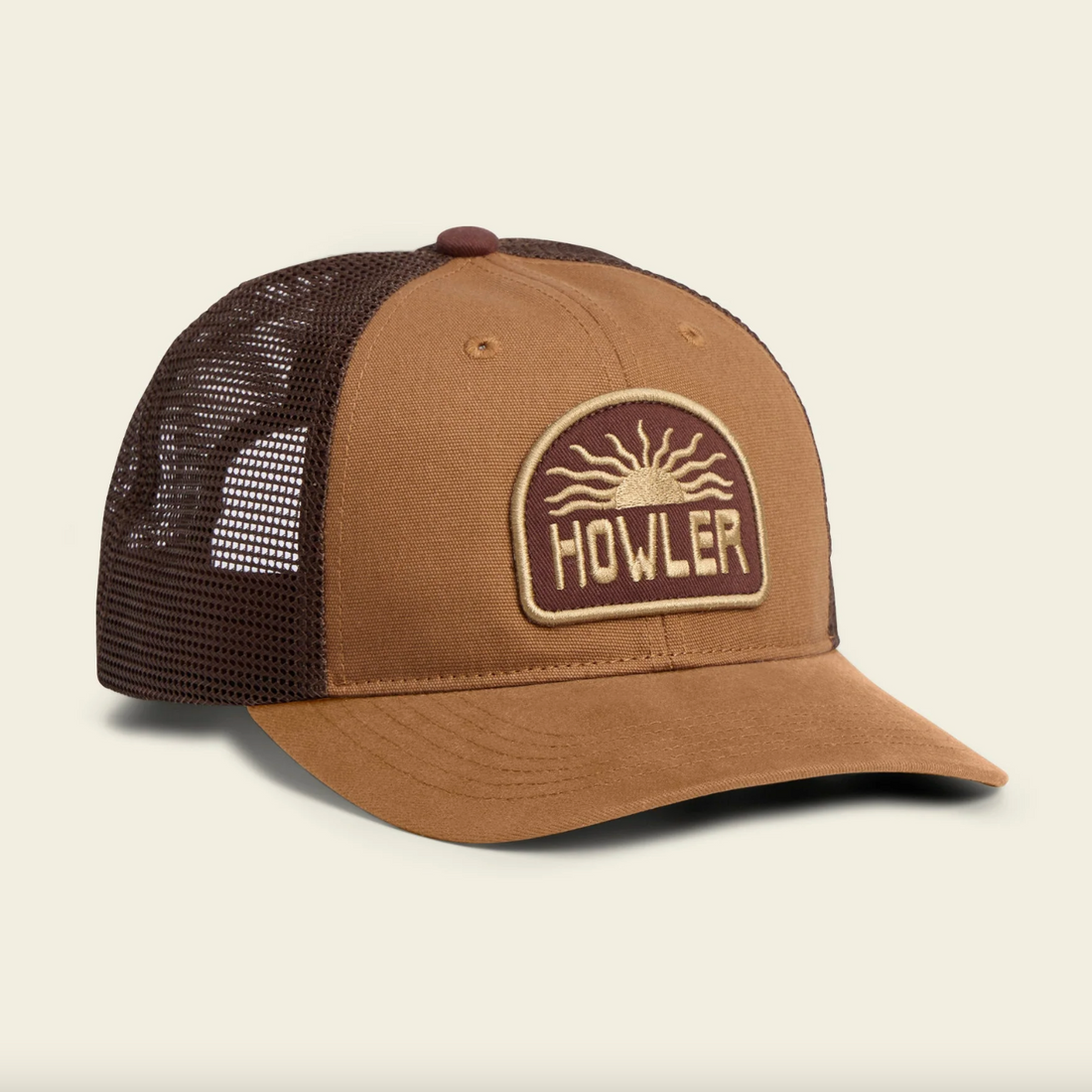Brown and black mesh cap with 'Howler' logo on a beige background