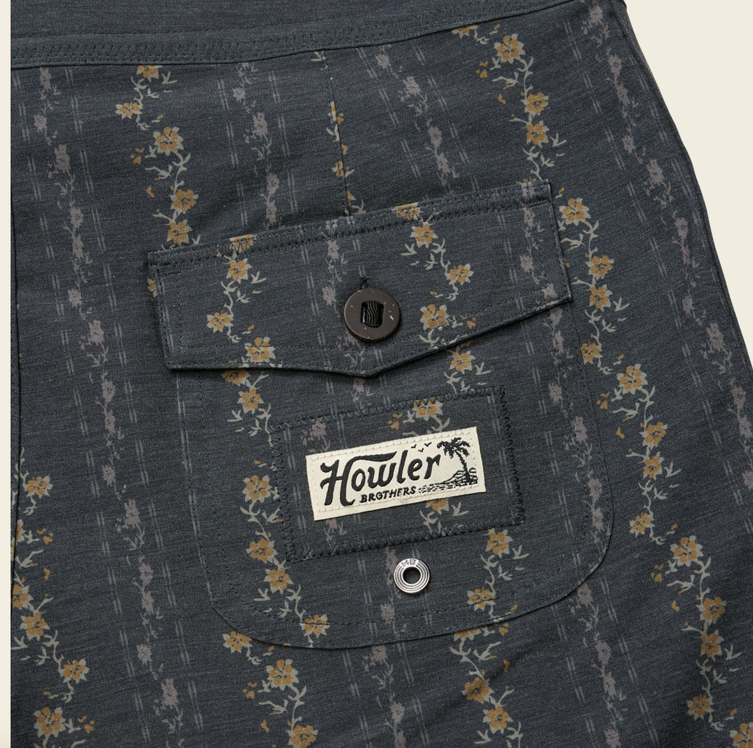 Dark gray shorts with a subtle pattern on a beige background
