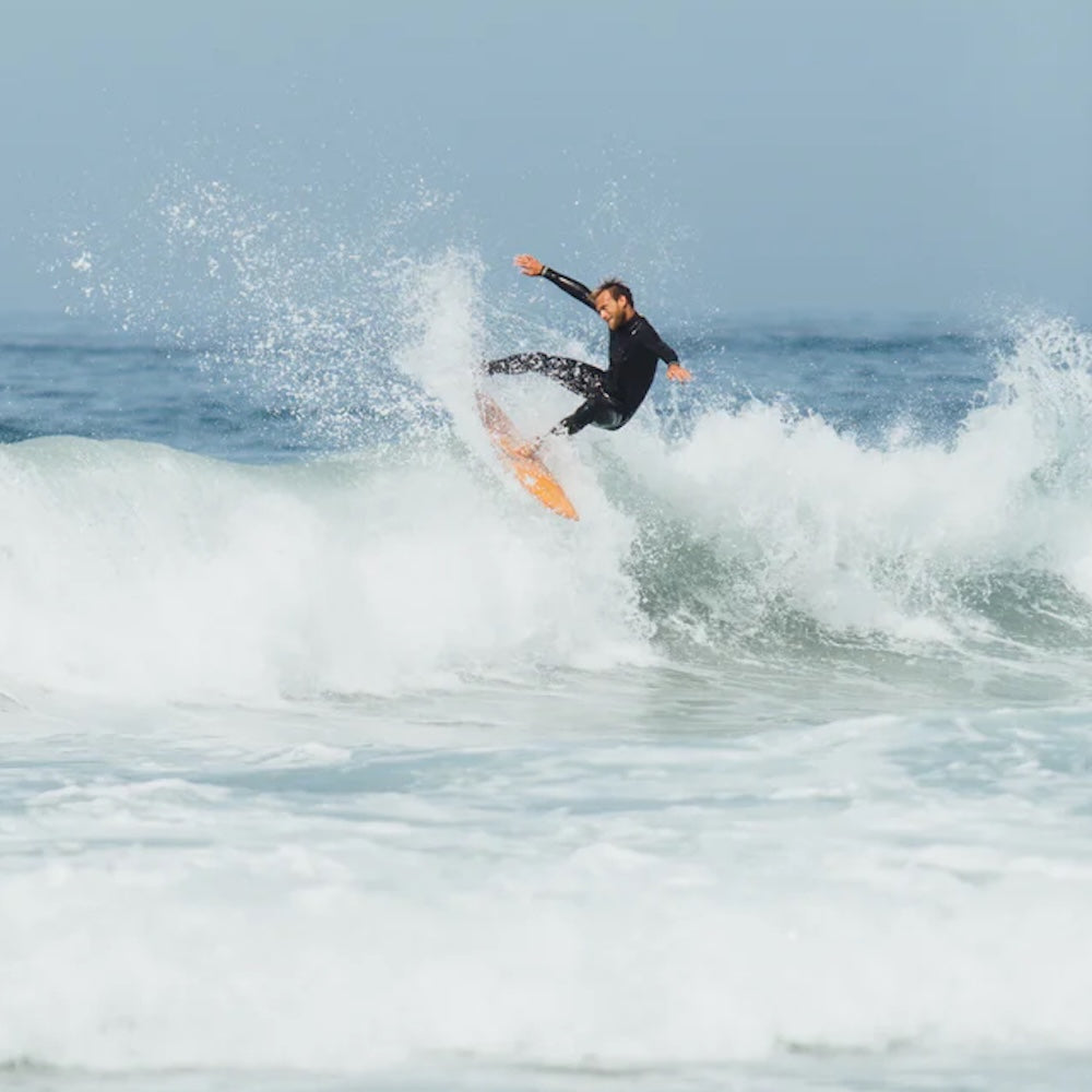 Person surfing on a wave in the ocean