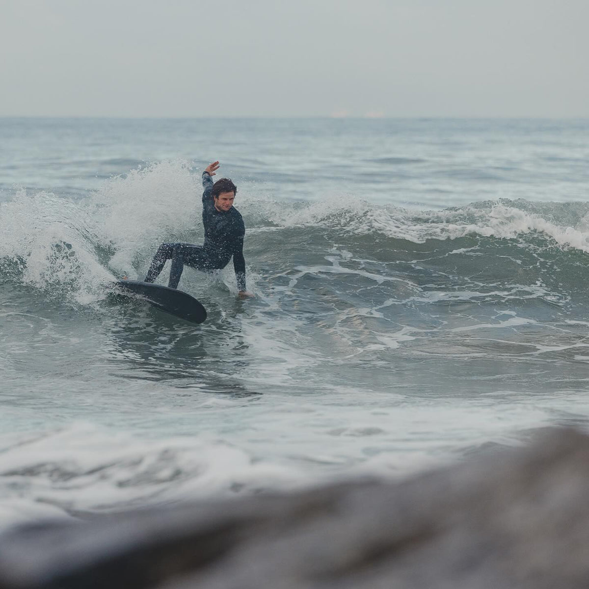 Person surfing on a wave in the ocean