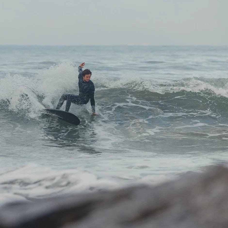 Person surfing on a wave in the ocean