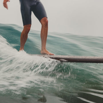Person surfing on a wave with a blurred background