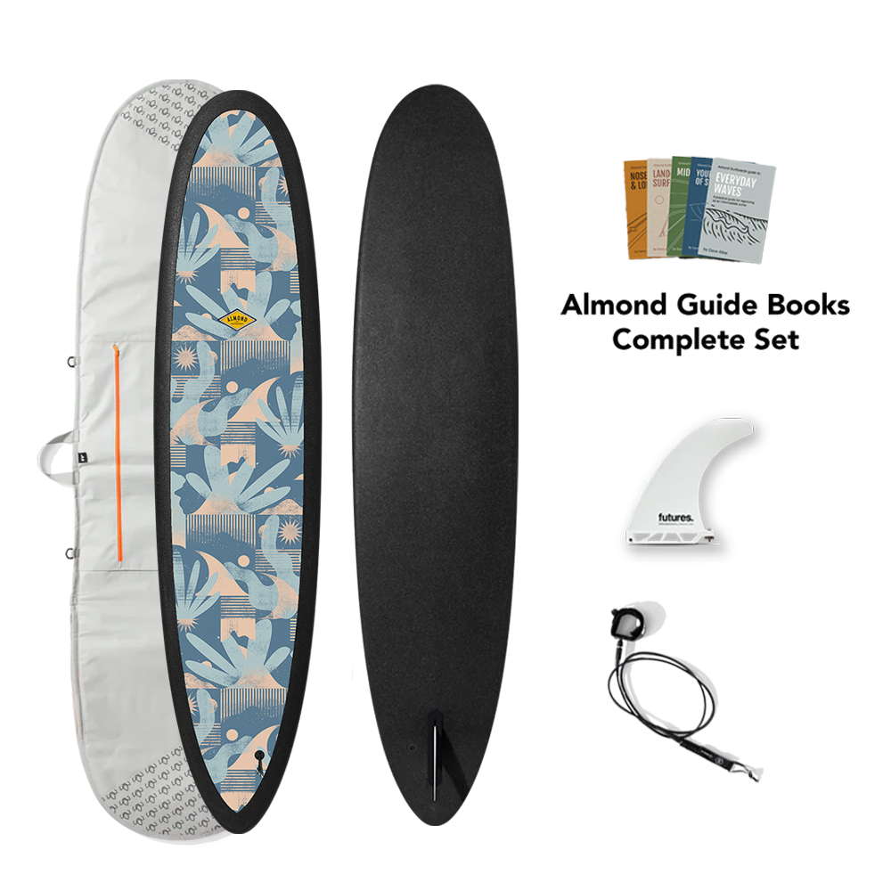 Surfboard with cover, fins, and guide books on a white background