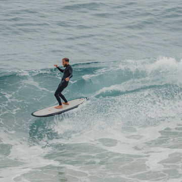 Person surfing on a wave in the ocean