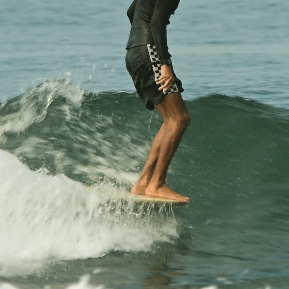 Person surfing on a wave with water splashing around