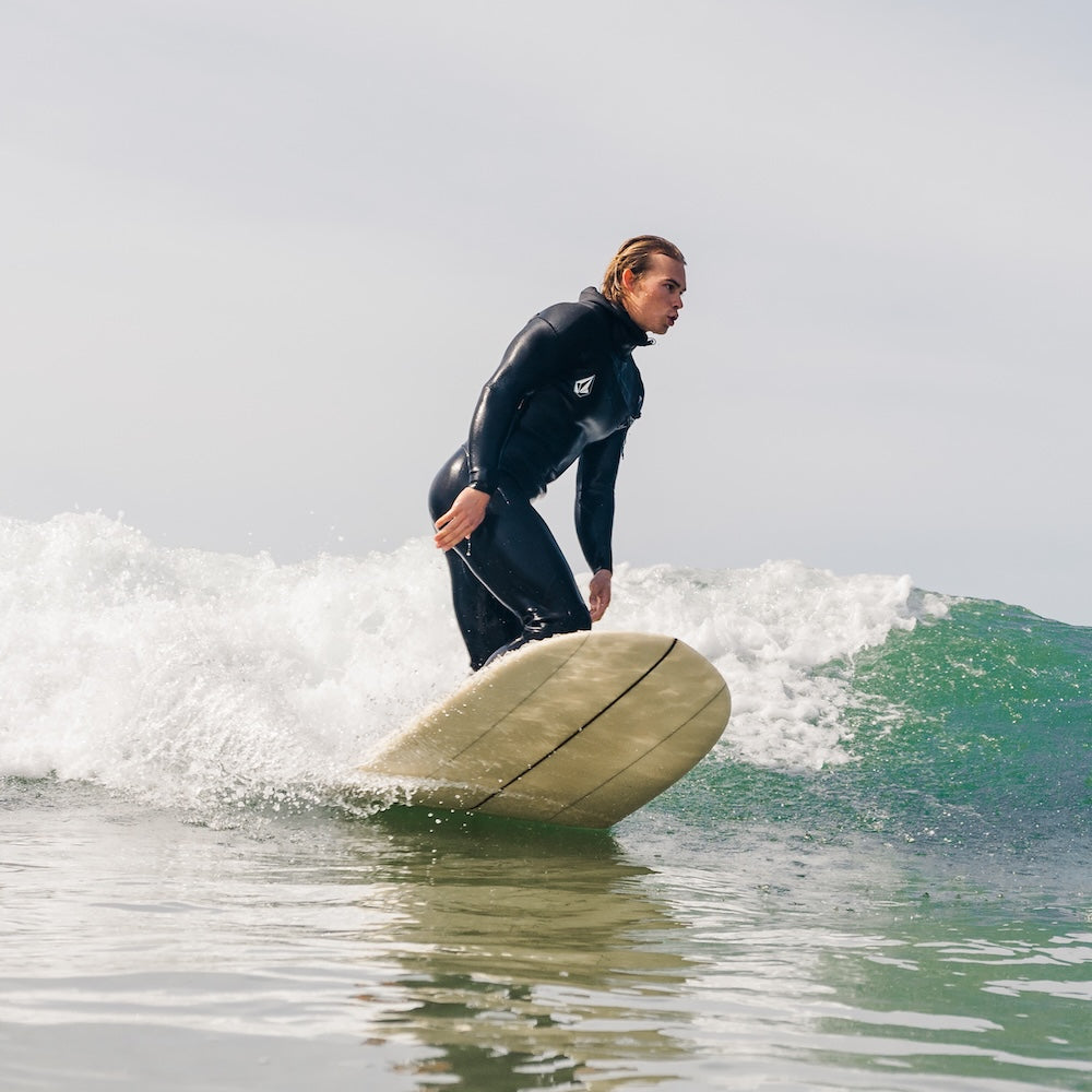 Person surfing on a wave in the ocean