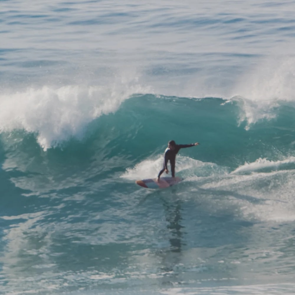 Person surfing on a wave in the ocean