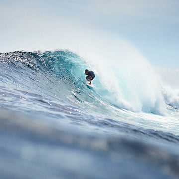 Surfer riding a large wave in the ocean