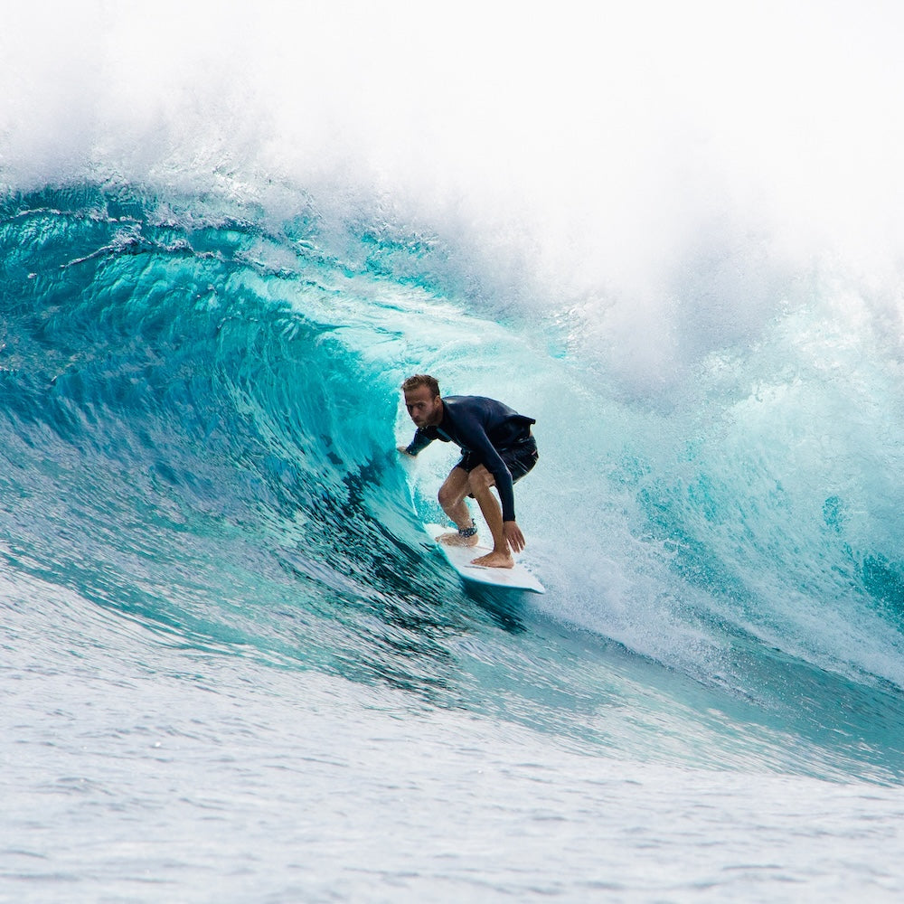Surfer riding a large wave in the ocean
