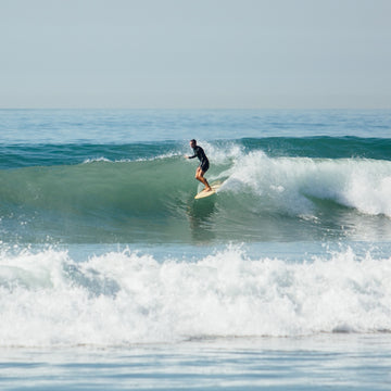 Person surfing on a wave in the ocean