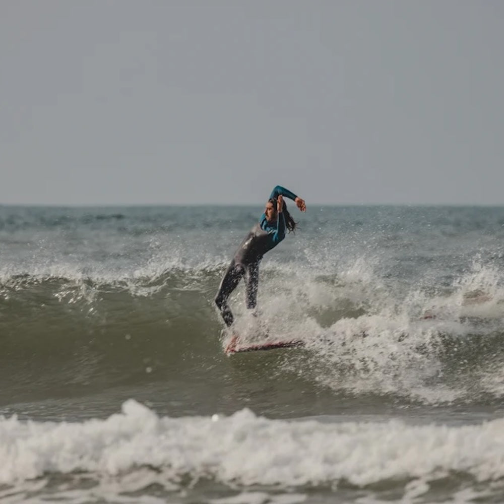 Person surfing on a wave in the ocean