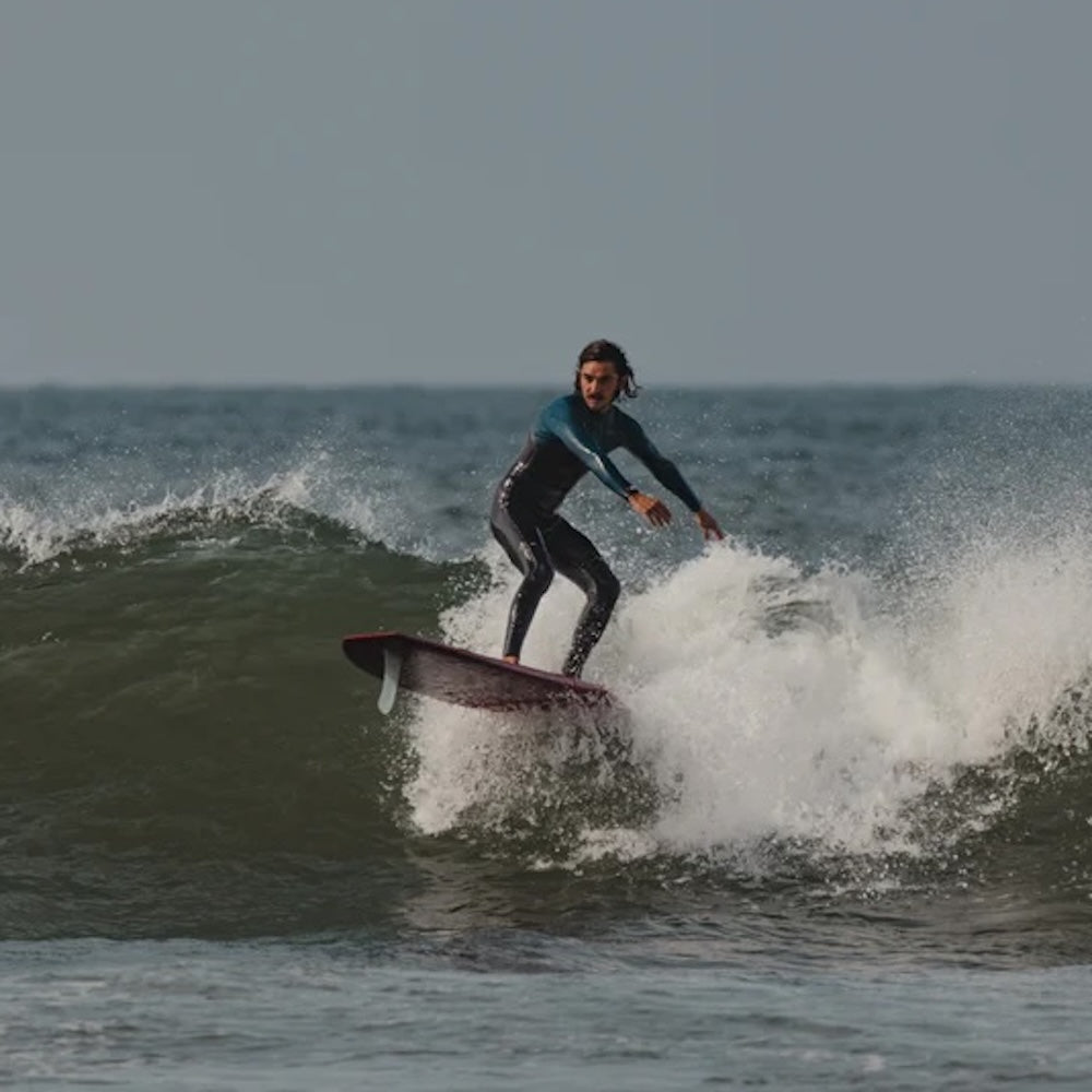 Person surfing on a wave in the ocean
